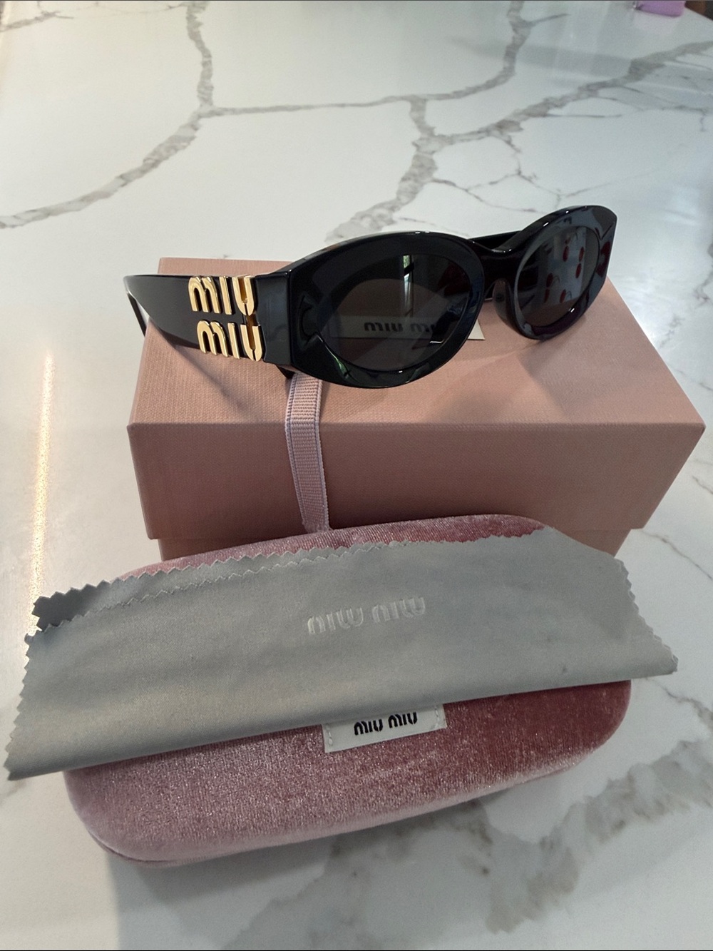 Miu Miu Black Oval Sunglasses with Gold Logo Temples